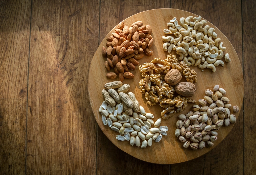 9 Healthy Foods That Lift Your Mood Naturally | Feel Happier Every Day 7 Various nuts type wooden plate