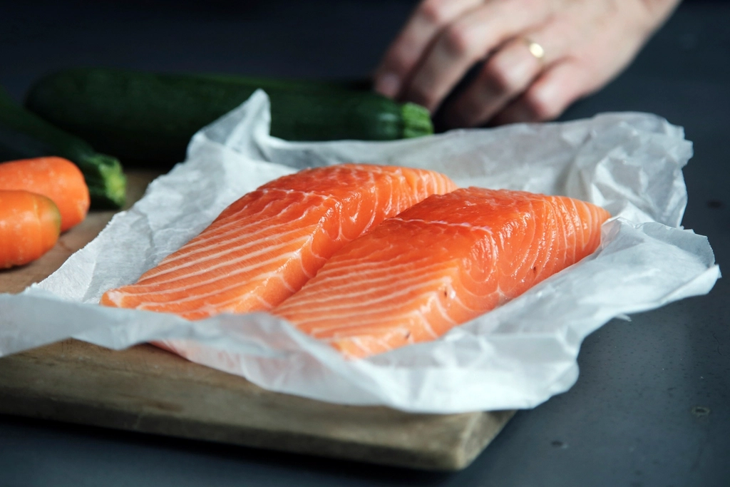 9 Healthy Foods That Lift Your Mood Naturally | Feel Happier Every Day 2 raw salmon fish fillets